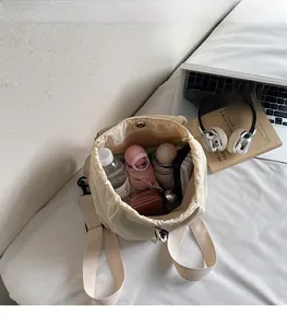 Top view of open beige canvas backpack showing large capacity for water and umbrella