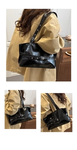 Detail of glossy black faux leather tote featuring silver eyelet buckles and urban style