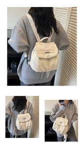 Macro detail of the creamy white nylon backpack showing textured fabric and brand logo tag
