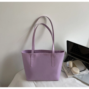 Close-up of a lavender purple faux leather tote bag with long shoulder straps for daily commuting