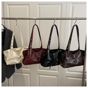 Detail view of four glossy tote bags in ivory, burgundy, black, and dark brown colors