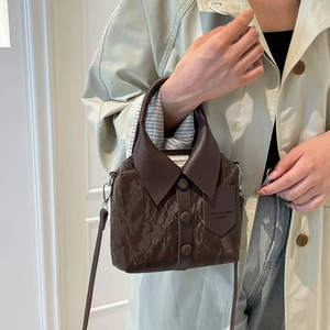 Coffee brown shirt-style bucket bag with button details and adjustable shoulder strap