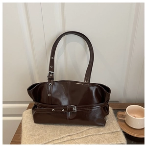 Close-up of the glossy dark chocolate leather tote with silver buckle strap details