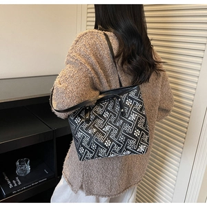 Lifestyle shot of large vintage floral tote bag worn over the shoulder with knit sweater