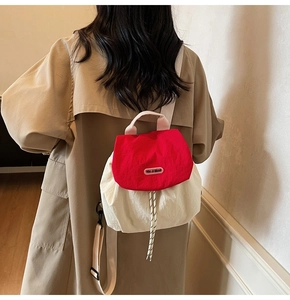Detail of red and off-white nylon backpack with drawstrings and brand logo label