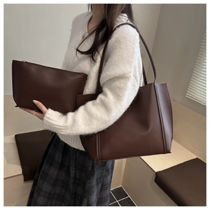 Deep brown tote bag set with matching zipper pouch worn by model for daily use