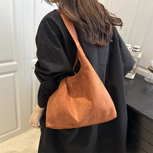 Minimalist caramel brown suede tote bag with wide shoulder strap for everyday fashion