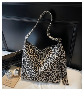 Detail of leopard print canvas tote bag featuring a black 'FASHION' tag and thick texture