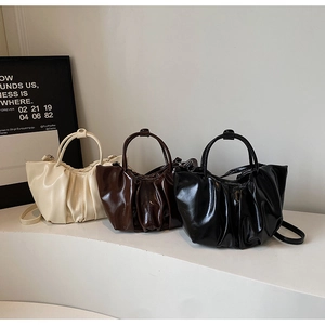 Detailed display of French pleated cloud bags in cream, chocolate, and classic black colors