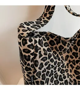 Detailed close-up of leopard print woven fabric and FASHION label on the tote bag