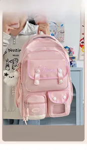 Pink multi-pocket school backpack with plush puppy charm in a student dormitory setting