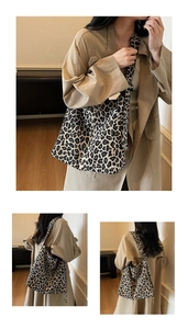 Detailed macro view of high-capacity leopard print canvas tote bag with woven fashion tag