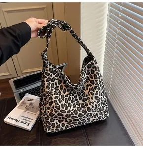 Detail of the leopard print canvas tote bag showing the thick fabric texture and wide strap