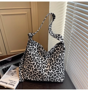 Detail of black and white leopard canvas tote with adjustable strap and hobo silhouette