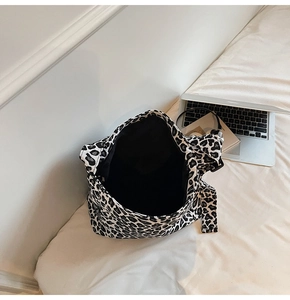 Spacious interior of leopard print canvas tote bag showing large storage capacity