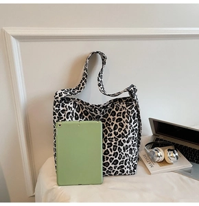 Leopard print canvas tote bag shown with a tablet to demonstrate large capacity