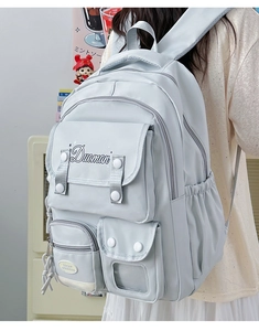 Detail of light blue waterproof backpack featuring flap closure and functional pockets