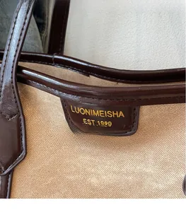 Gros plan sur l'étiquette en cuir et le tissu en toile d'un grand sac cabas