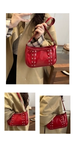 Detail of red patent leather shoulder bag with vintage silver studs and glossy finish