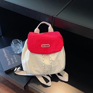 Minimalist red and white nylon backpack featuring a drawstring closure and logo detail