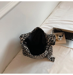 Detailed view of the leopard print canvas tote with its spacious black lined interior