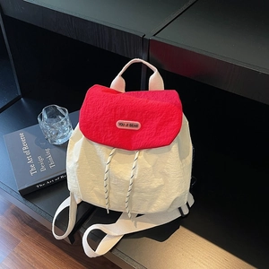Minimalist nylon backpack with red and white color blocking and drawstring flap closure