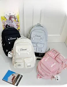 Detailed view of large capacity school backpacks in four colors with plush pendants