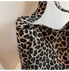 Detail of leopard print jacquard canvas tote showing rich texture and fashion label