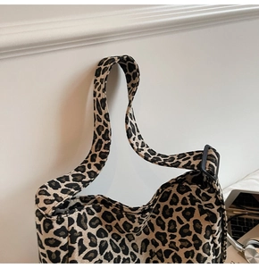 Detail of leopard print canvas tote bag with adjustable strap and spacious interior