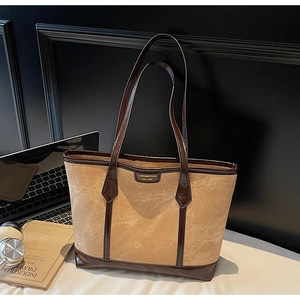 Détail du sac cabas en daim kaki avec cuir verni marron contrasté et logo de marque
