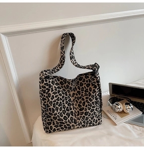 Close-up of leopard print canvas tote bag with wide strap and fashion side label
