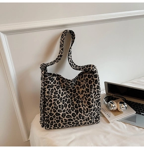 Detailed view of leopard print canvas tote bag with adjustable strap and large capacity