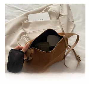 Interior view of brown suede tote bag showing large capacity for wallet and cosmetics
