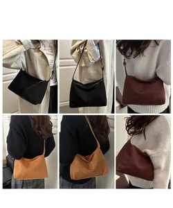 Detail view of suede tote bags in black, dark brown, and caramel with adjustable straps