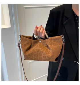Detailed view of the leopard print tote bag with soft texture and silver hardware