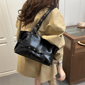 Glossy black patent leather tote bag with silver buckle and chic Y2K aesthetic