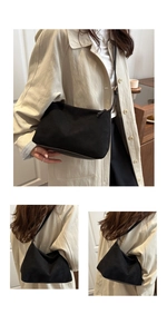 Detail of minimalist black suede tote bag with matte texture and sleek shoulder strap