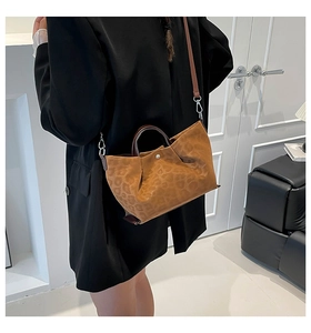 Detail of vintage leopard print tote bag with removable strap shown on model side