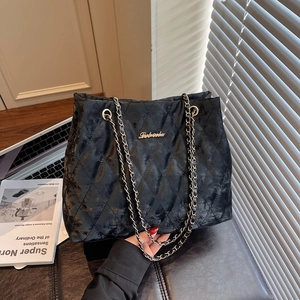 Classic black velvet quilted tote bag with golden chain strap and logo detailing
