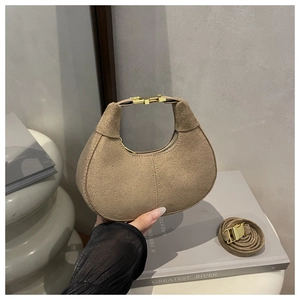 Detail of vintage matte mini bag with gold buckle handle and adjustable crossbody strap