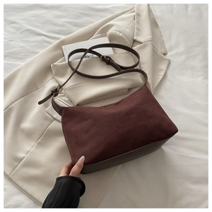 Detail of vintage matte suede shoulder bag in dark brown with smooth leather straps