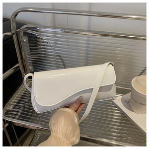 Chic white patent leather handbag with a unique asymmetric wavy flap and slim strap