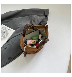 Detail view of large brown felt tote bag with interior storage for phone and accessories