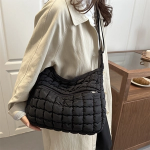 Quilted black hobo shoulder bag with puffy puff texture and metal zipper closure