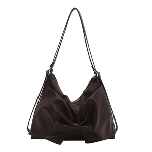 Brown leather shoulder bag for women with large bow design and top zipper closure