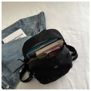 Close-up of black nylon backpack interior layers showing tablet and book compartments