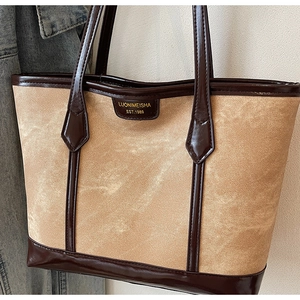 Détail de la toile de qualité et des finitions en cuir marron d'un sac cabas vintage