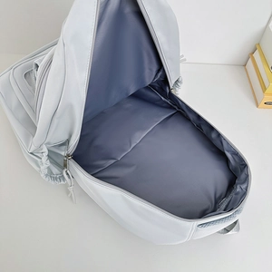 Light gray large capacity nylon backpack with a spacious main compartment and metal zippers