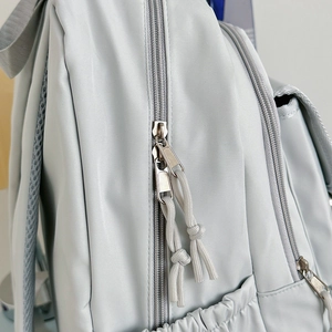 Light gray large capacity nylon backpack with double zippers and elastic side pockets
