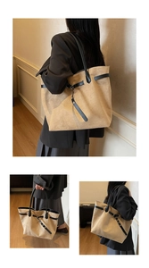 Detail of vintage beige suede tote bag with black leather straps and adjustable buckles